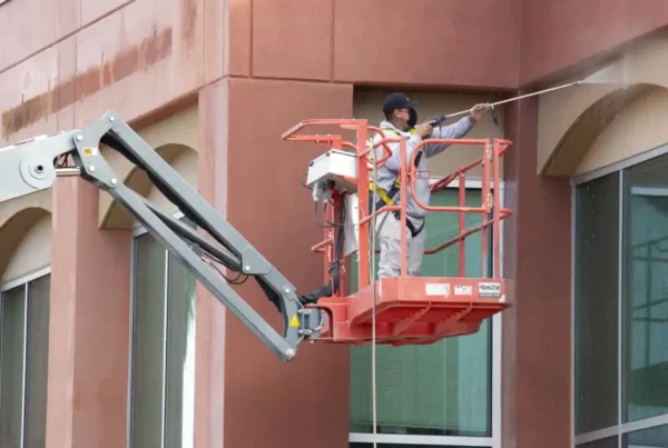 guy pressure washing a building